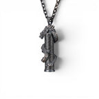 The Dragon — scale shot of the dragon pendant in hand.
