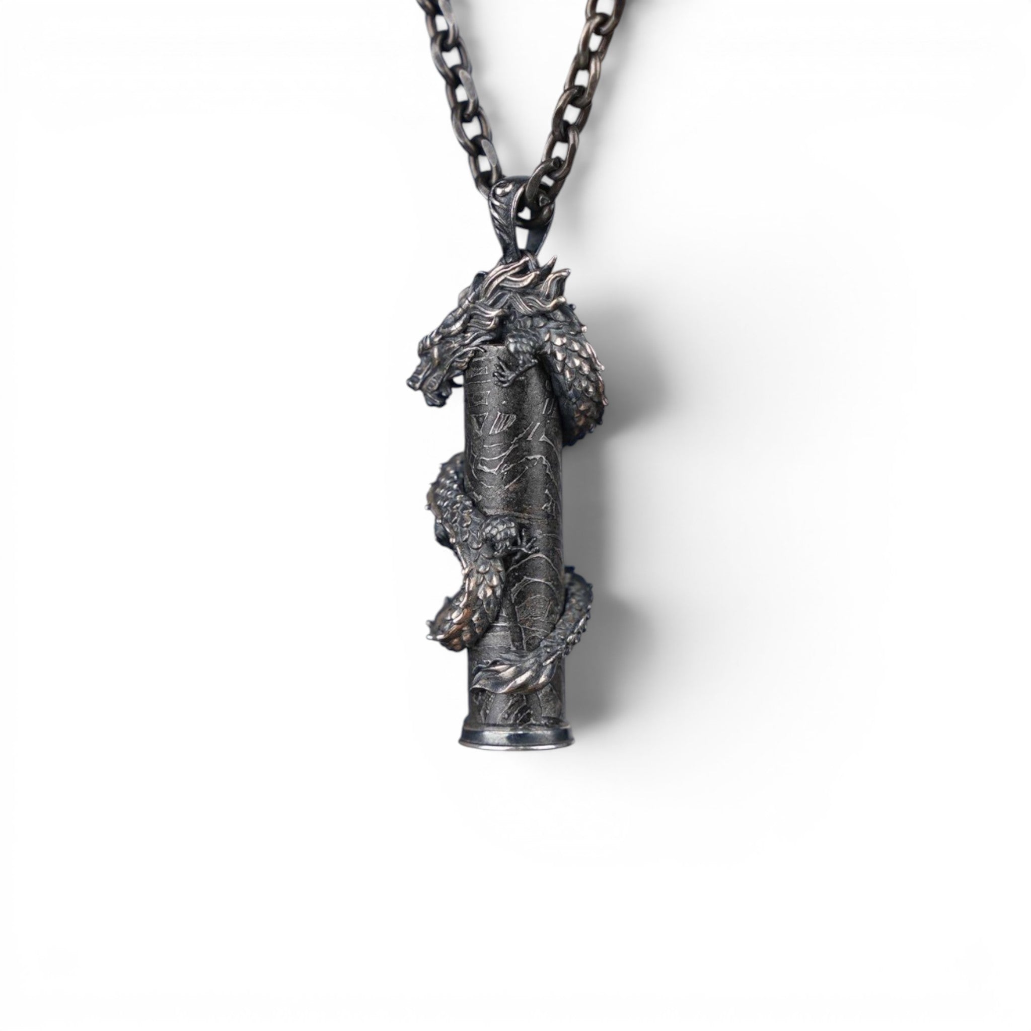 The Dragon — scale shot of the dragon pendant in hand.