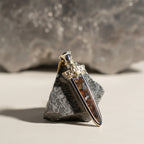 The Pallas Blade — front view of the blade pendant on dark background.