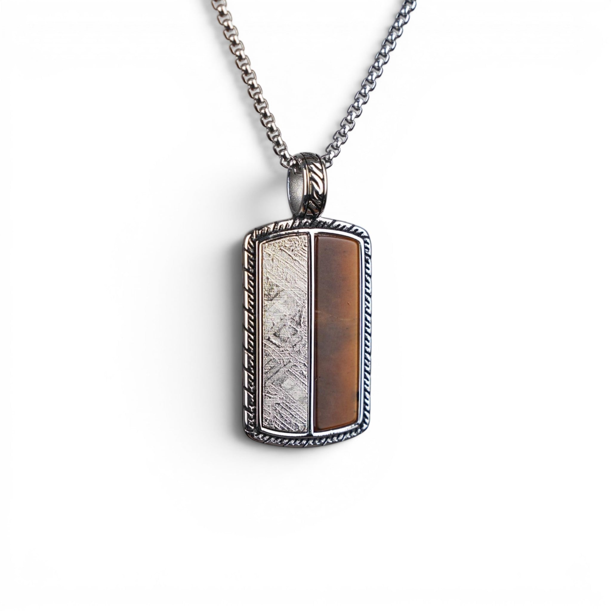 The Tiger Tag — detail of the rope-twist engraved border and carved bail.
