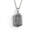 The Vault Tag — detail of the brushed titanium-grade steel frame and satin finish.