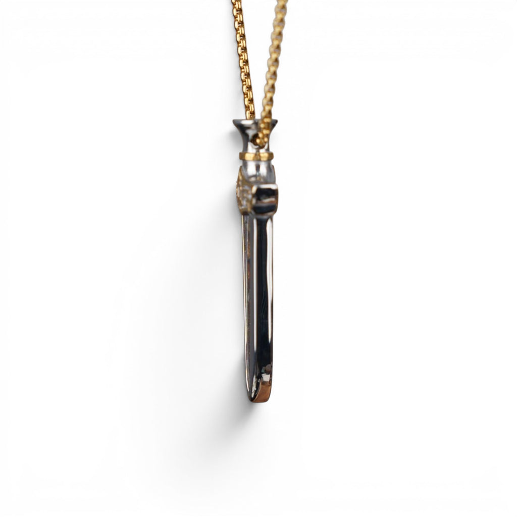 The Pallas Blade — scale shot of the blade pendant in hand.