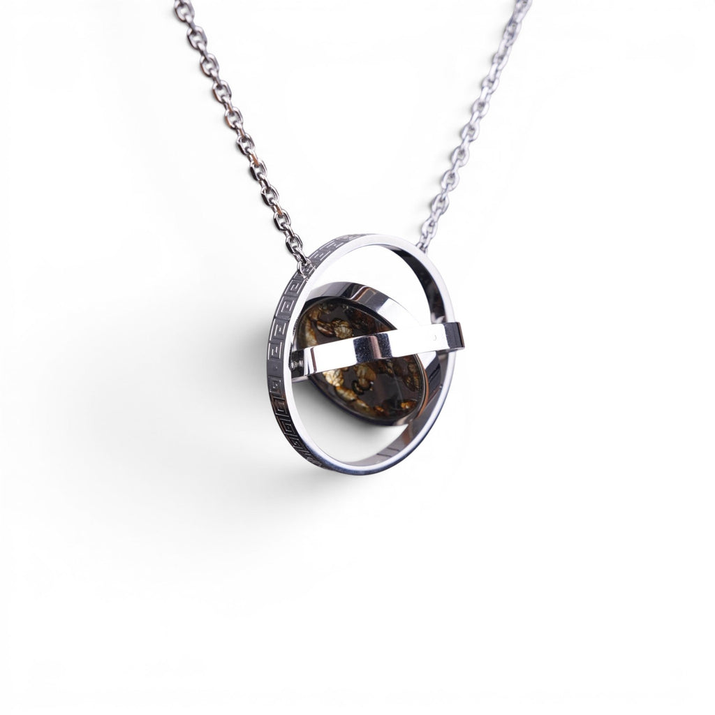 The Pallas Orrery — scale shot of the orrery pendant in hand.