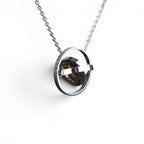 The Pallas Orrery — scale shot of the orrery pendant in hand.