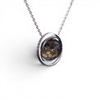 The Pallas Orrery — pallasite pendant worn at the chest, men's heritage jewellery.