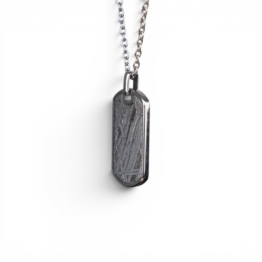 The Field Tag — meteorite dog tag worn on cable chain at the chest, men's heritage jewellery.