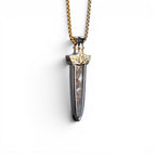 The Pallas Blade — pallasite pendant on heavy gold-tone box chain.