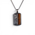 The Tiger Tag — front view of the split-face tag on dark background.