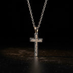 The Cross by Pallas 1772 — Aletai iron meteorite cross pendant in polished titanium-grade steel frame with crystalline Widmanstätten pattern, on cable chain.